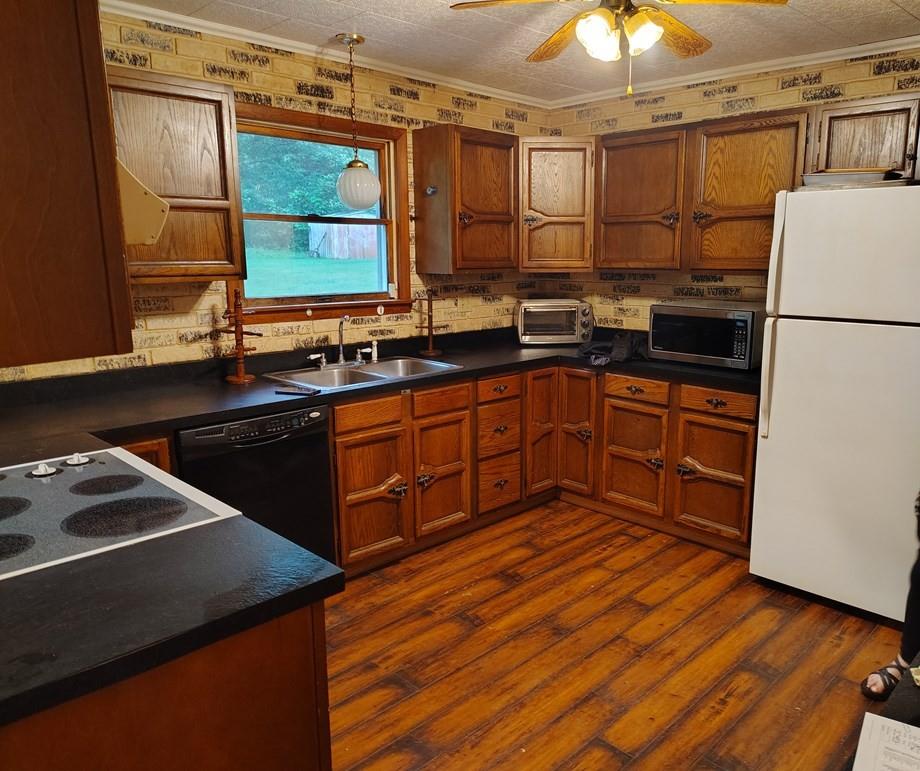 134 Railroad Street Oak Ridge, PA 16245 - Photo 7 of 20 a kitchen with stainless steel appliances granite countertop a sink stove and refrigerator
