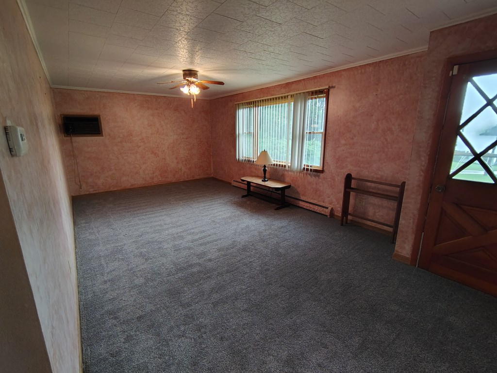 134 Railroad Street Oak Ridge, PA 16245 - Photo 9 of 20 an empty room with windows and ceiling fan