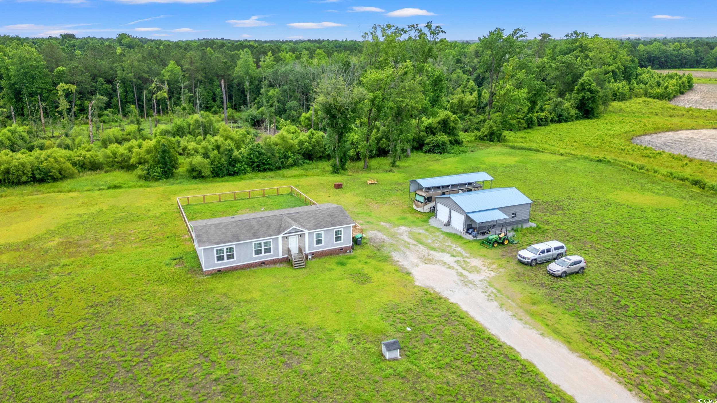 399 Calico Road Loris, SC 29569 - Photo 1 of 30 View from above of property with a heavily wooded area
