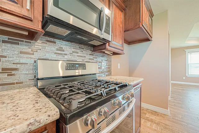 a stove top oven sitting inside of a kitchen