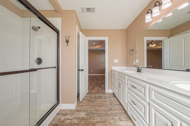 a bathroom with a double vanity sink and a mirror