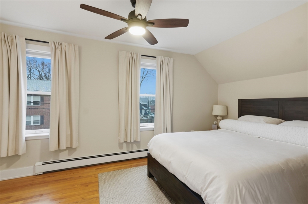 24 Minot Street Reading, MA 01867 - Photo 15 of 34 a bedroom with a large bed and a chandelier
