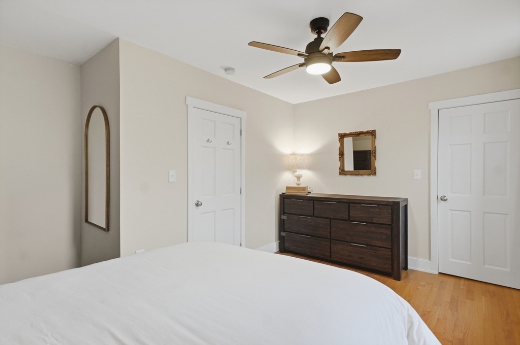 24 Minot Street Reading, MA 01867 - Photo 16 of 34 a bedroom with a bed and a chandelier
