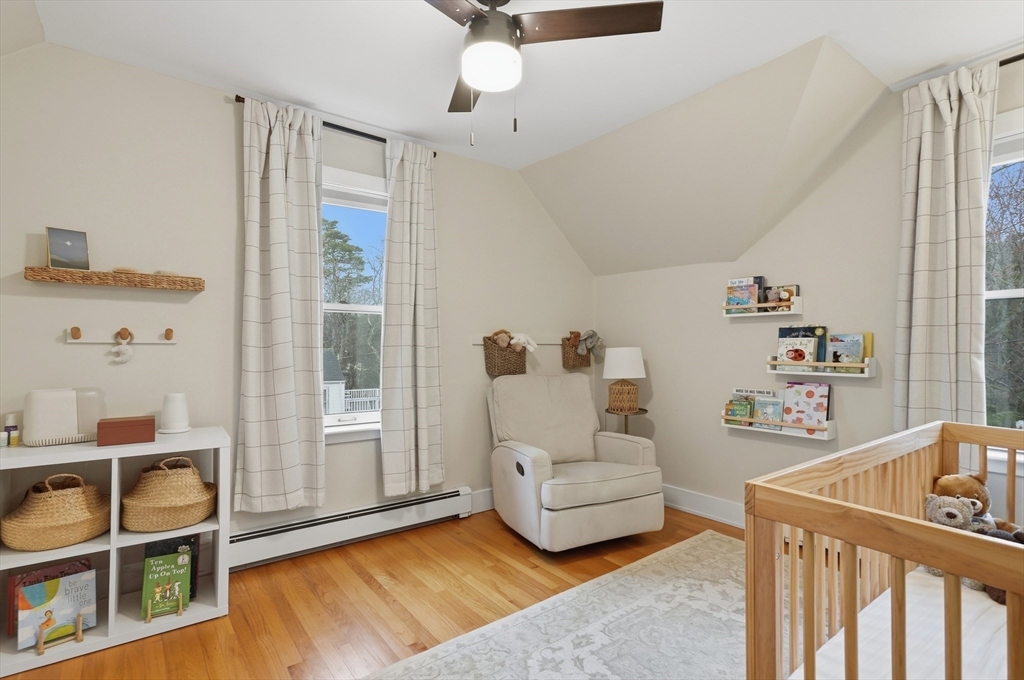 24 Minot Street Reading, MA 01867 - Photo 20 of 34 a living room with furniture and a book shelf