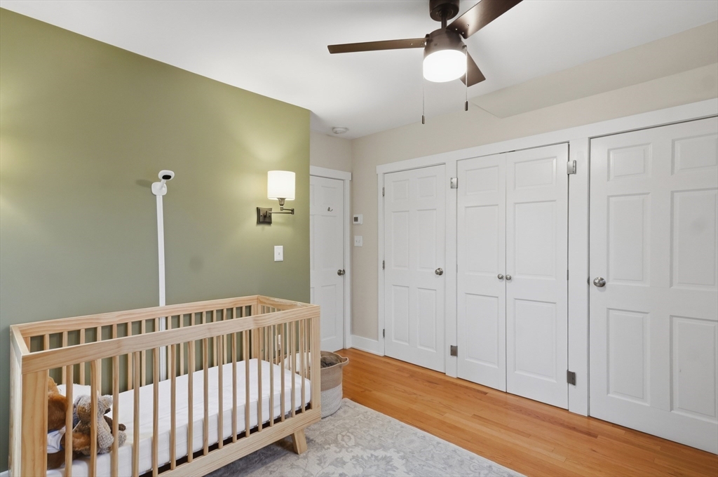 24 Minot Street Reading, MA 01867 - Photo 21 of 34 a view of a bedroom with wooden floor & fan