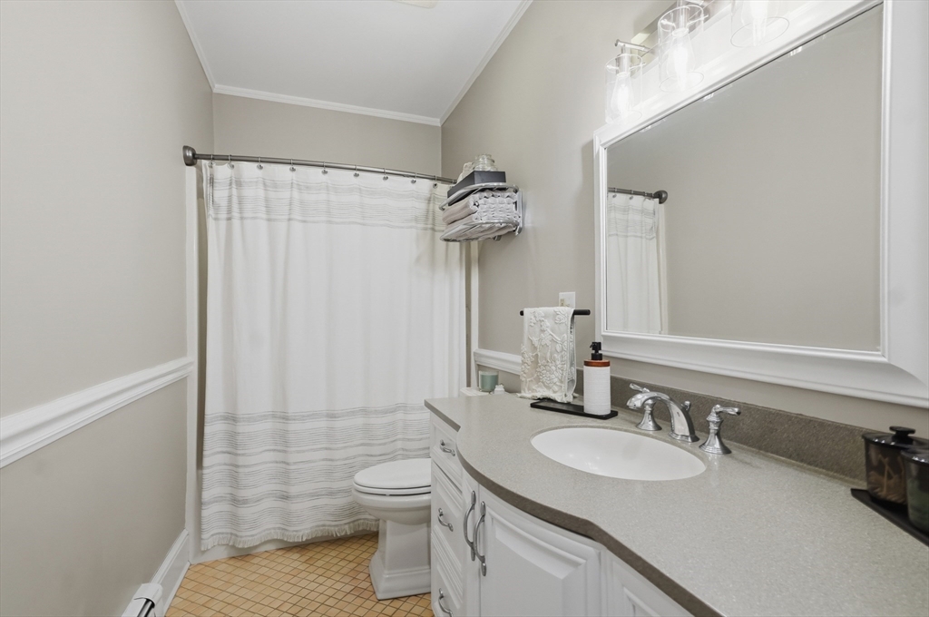 24 Minot Street Reading, MA 01867 - Photo 22 of 34 a bathroom with a sink a toilet and shower