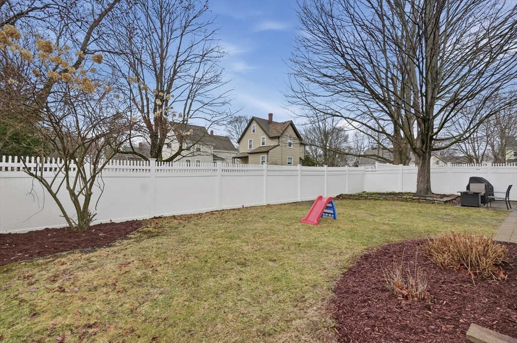 24 Minot Street Reading, MA 01867 - Photo 27 of 34 a backyard of the house with trees