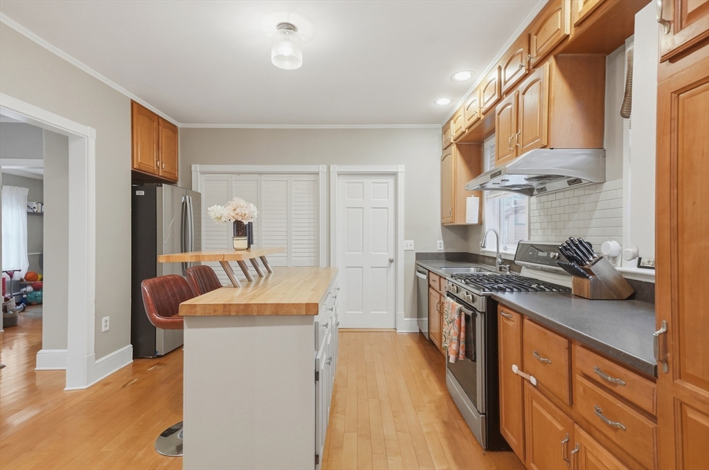 24 Minot Street Reading, MA 01867 - Photo 7 of 34 a kitchen with stainless steel appliances granite countertop a stove and a refrigerator