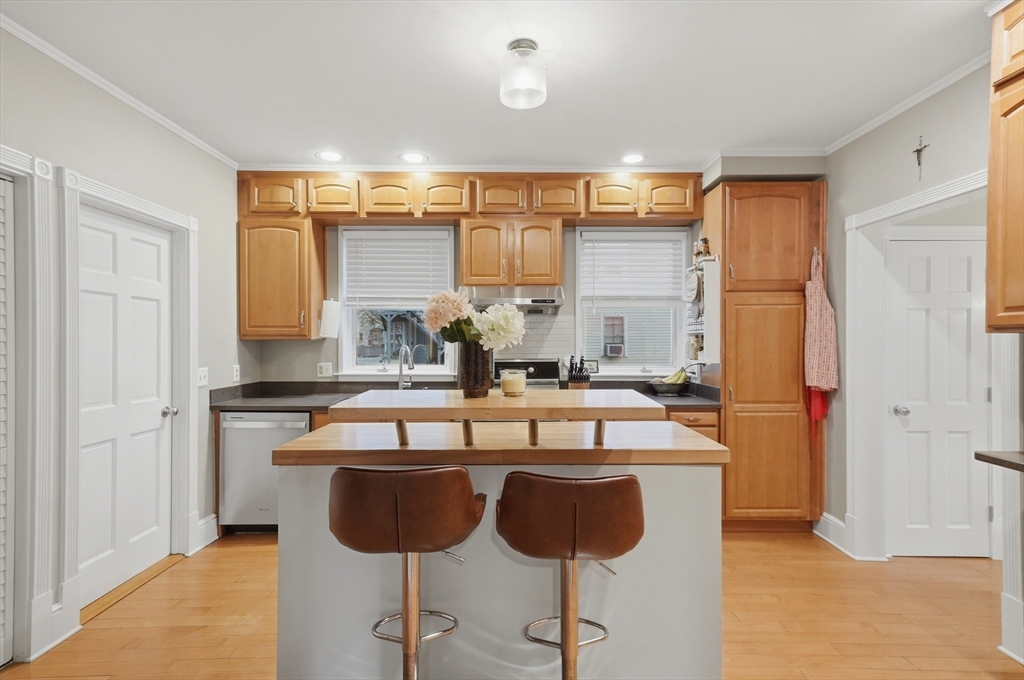 24 Minot Street Reading, MA 01867 - Photo 9 of 34 a kitchen with granite countertop a sink cabinets and stainless steel appliances