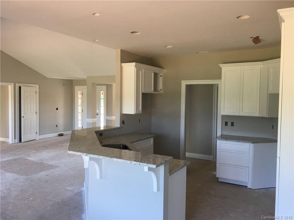3115 East Brief Road, Unit 3 Monroe, NC 28110 - Photo 4 of 12 a kitchen with stainless steel appliances kitchen island a refrigerator and a stove