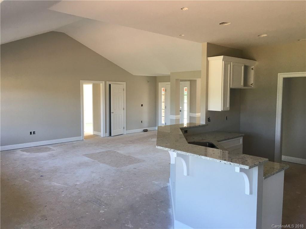 3115 East Brief Road, Unit 3 Monroe, NC 28110 - Photo 5 of 12 a kitchen with stainless steel appliances granite countertop a refrigerator and a stove