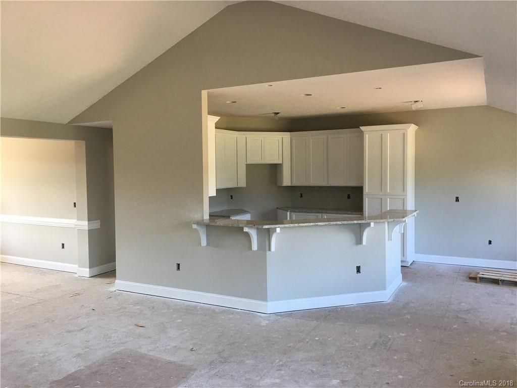 3115 East Brief Road, Unit 3 Monroe, NC 28110 - Photo 6 of 12 a kitchen with granite countertop a sink and cabinets