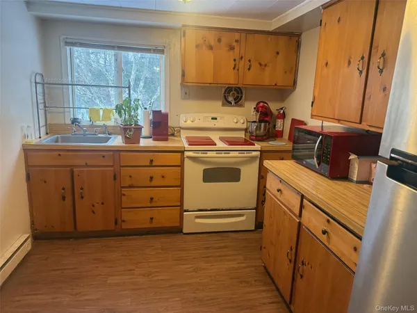 a kitchen with sink a stove and cabinets