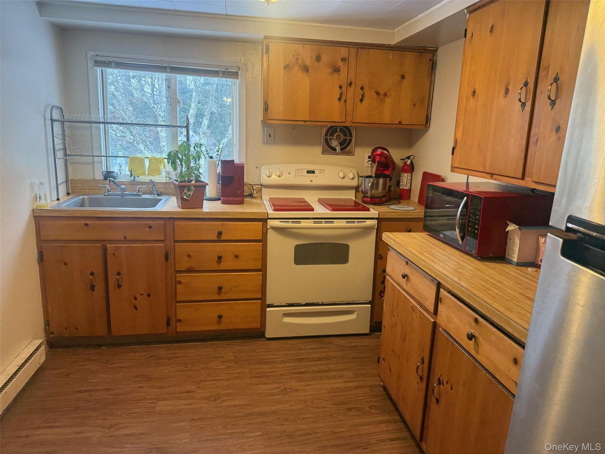 a kitchen with sink a stove and cabinets