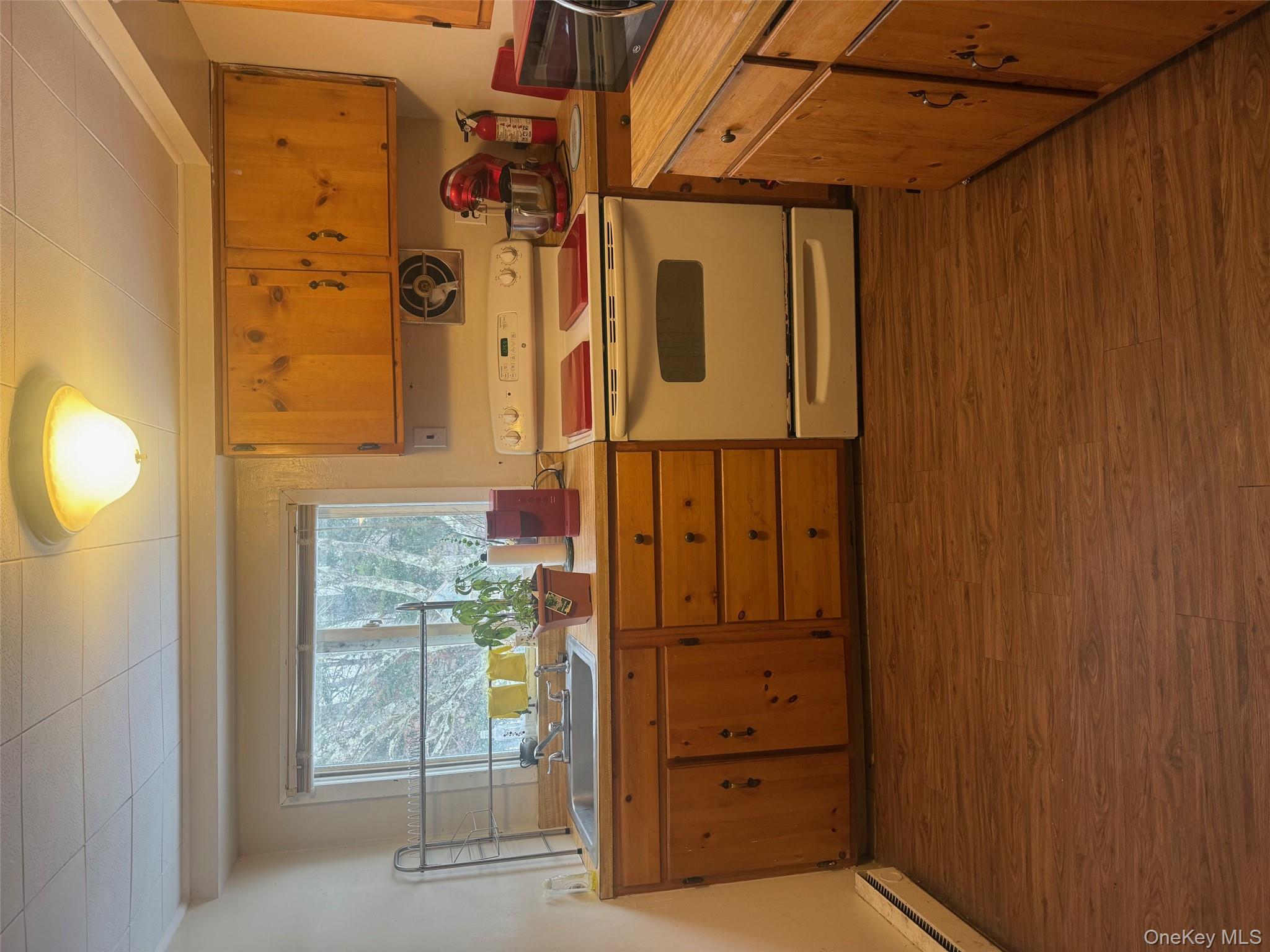 8 Beech Place Lake Peekskill, NY 10537 - Photo 16 of 19 a kitchen with stainless steel appliances granite countertop a sink and a stove next to a window