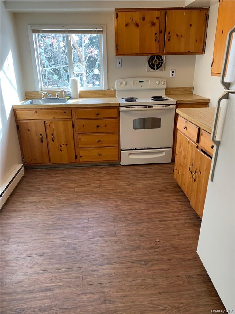 8 Beech Place Lake Peekskill, NY 10537 - Photo 8 of 19 a kitchen with granite countertop a stove a sink and a refrigerator