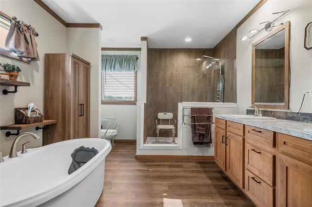 a spacious bathroom with a double vanity sink a and a large mirror
