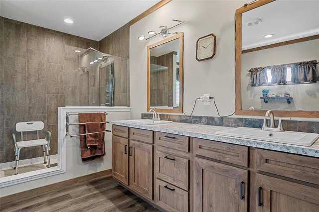 a spacious bathroom with a granite countertop sink and a mirror