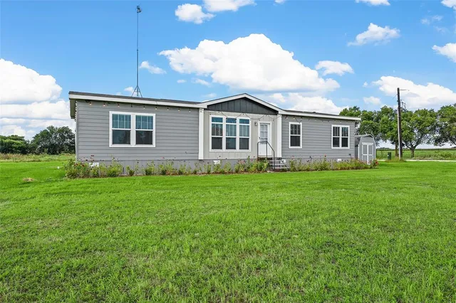 a view of a house with backyard and garden