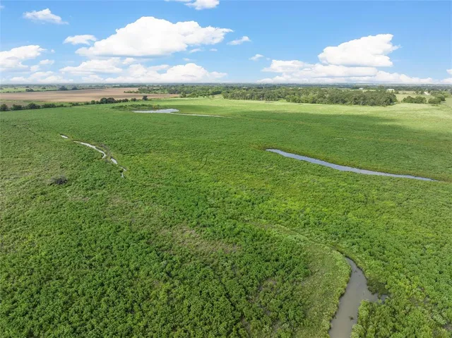 a view of a green field with clear sky