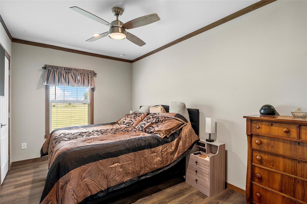 152 County Road 152 Riesel, TX 76682 - Photo 9 of 27 a bedroom with a bed and a chandelier