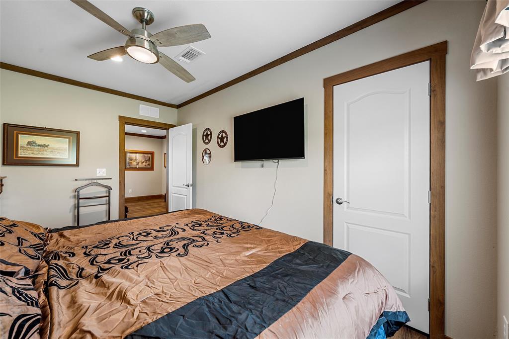152 County Road 152 Riesel, TX 76682 - Photo 10 of 27 a bedroom with a bed and a flat screen tv
