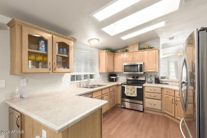 3301 South Goldfield Road, Unit 4086 Apache Junction, AZ 85119 - Photo 23 of 41 a kitchen with a stove a sink and a refrigerator
