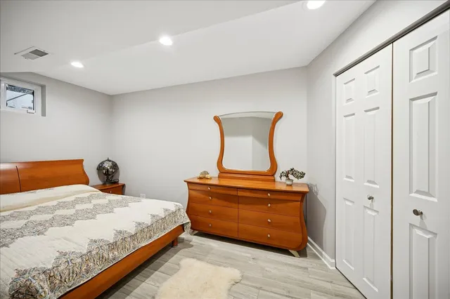 a bedroom with a bed and painting on the wall