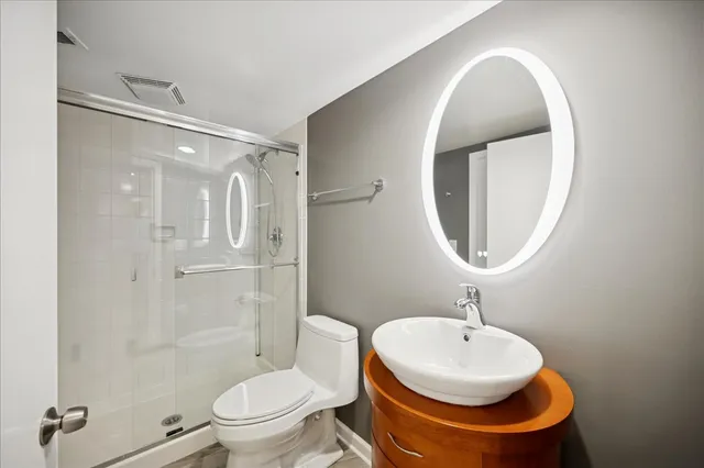 a bathroom with a toilet a sink and a mirror