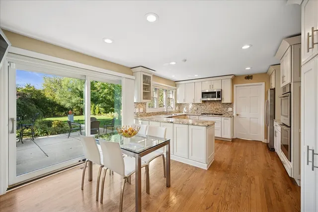 a kitchen with a table chairs refrigerator and cabinets