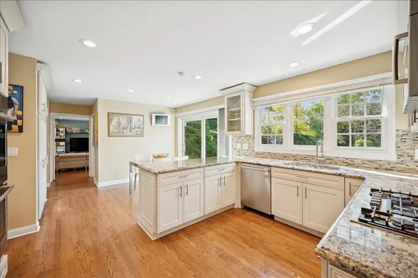 a open kitchen with stainless steel appliances granite countertop a stove and cabinets