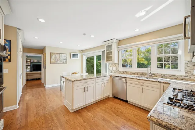 a open kitchen with stainless steel appliances granite countertop a stove and cabinets