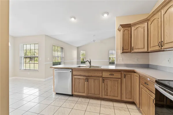a kitchen with a sink window and cabinets