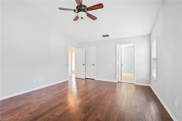a view of a room with wooden floor