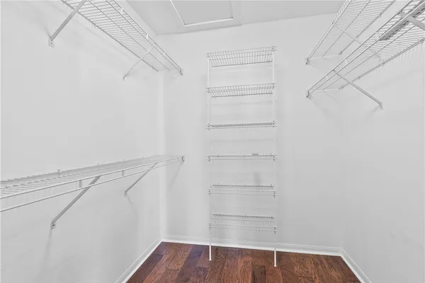 a view of walk in closet with empty racks