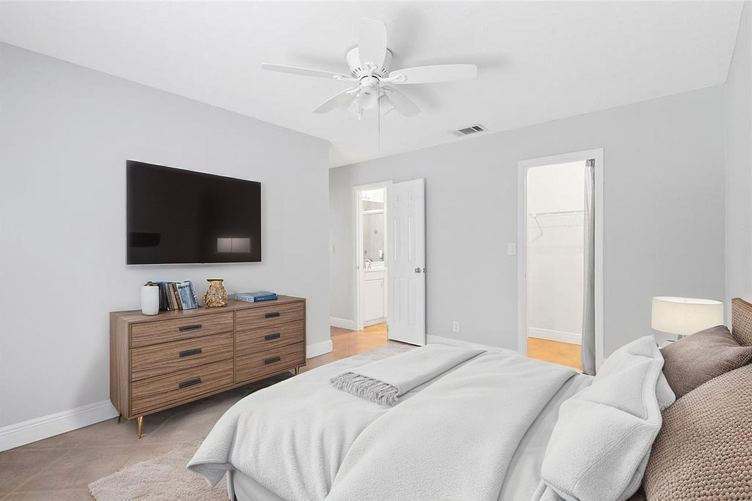 22840 Markham Way Boca Raton, FL 33428 - Photo 17 of 30 a bedroom with a bed and a flat screen tv
