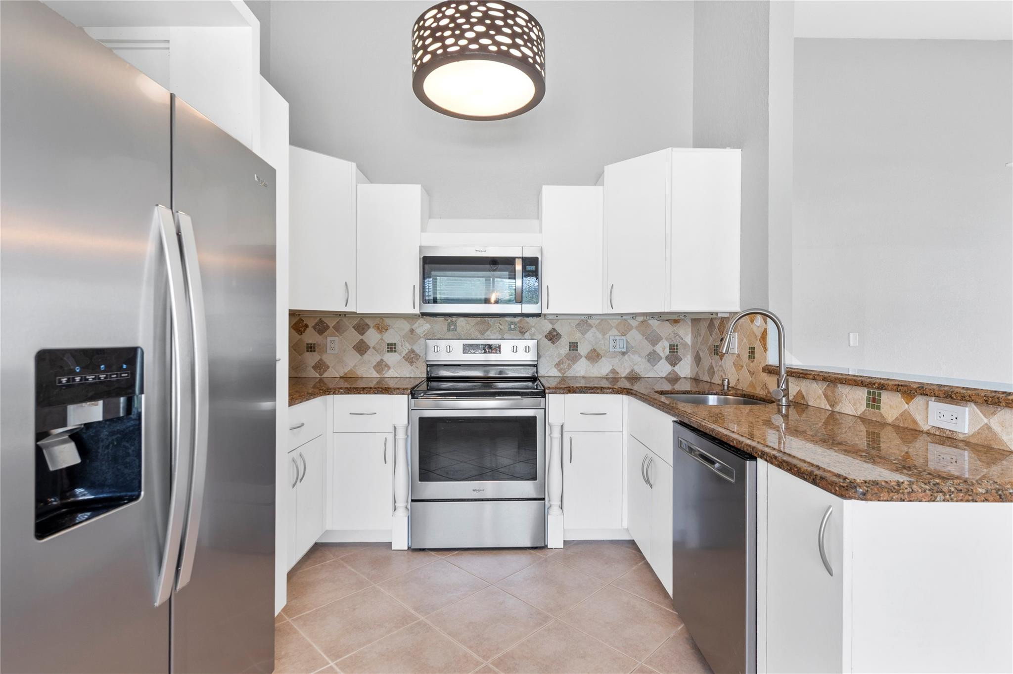 22840 Markham Way Boca Raton, FL 33428 - Photo 2 of 30 a kitchen with stainless steel appliances granite countertop a sink stove and refrigerator