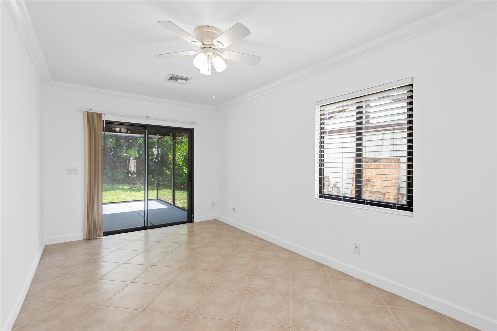 22840 Markham Way Boca Raton, FL 33428 - Photo 8 of 30 an empty room with chandelier fan and windows