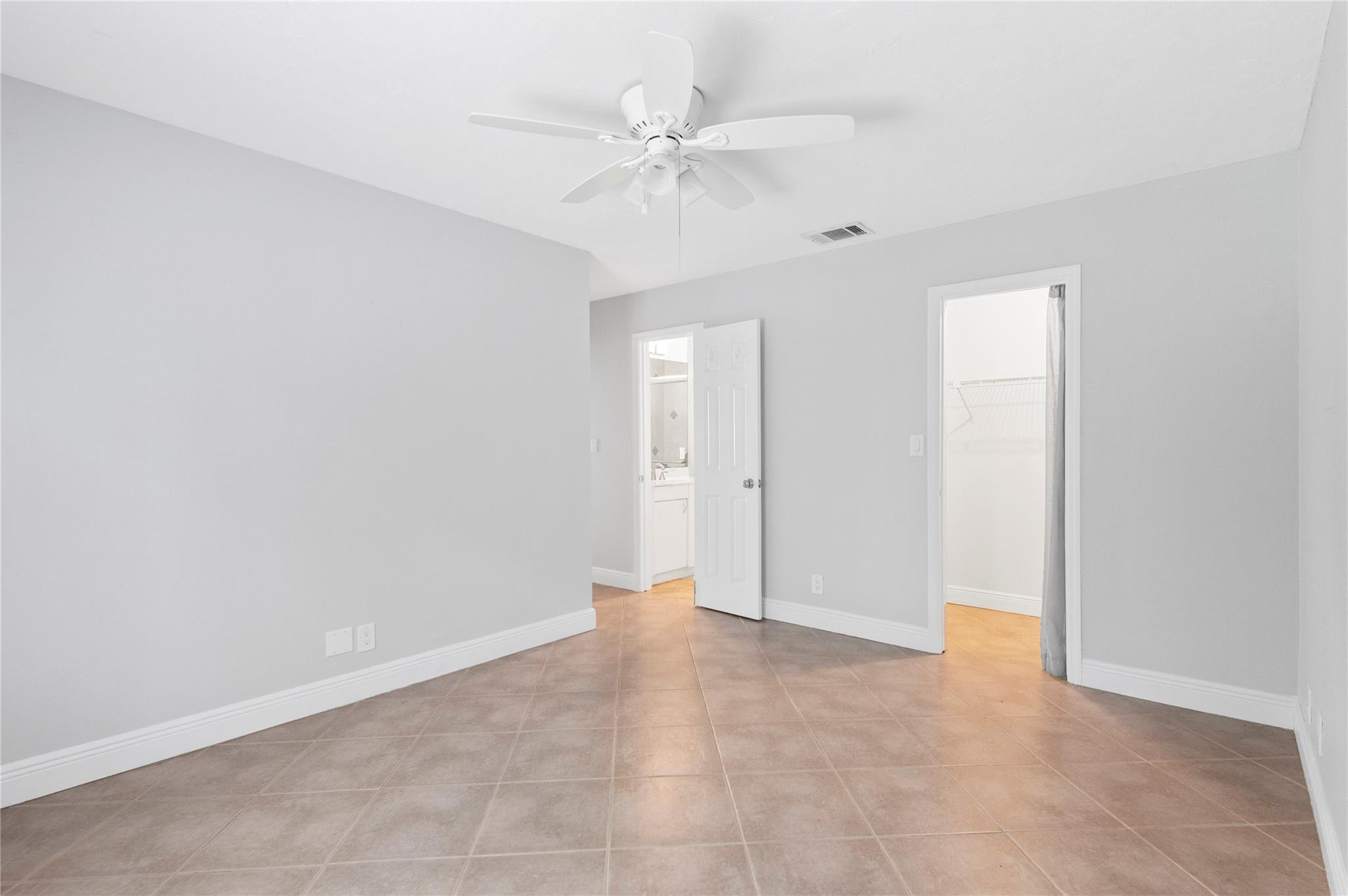 22840 Markham Way Boca Raton, FL 33428 - Photo 9 of 30 an empty room with a ceiling fan and a window