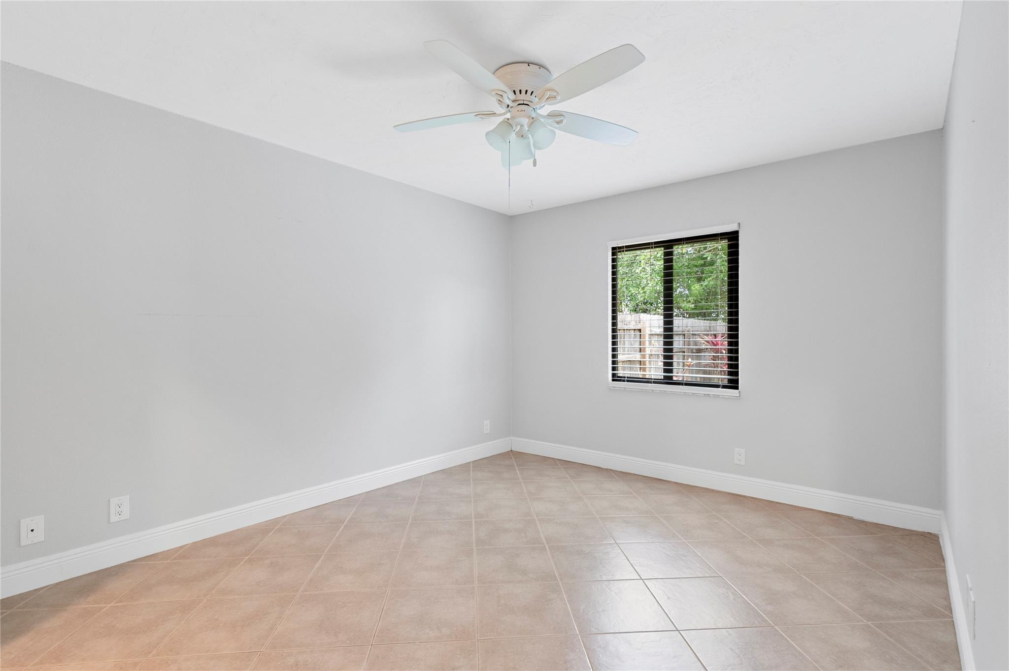 22840 Markham Way Boca Raton, FL 33428 - Photo 10 of 30 an empty room with a ceiling fan and windows