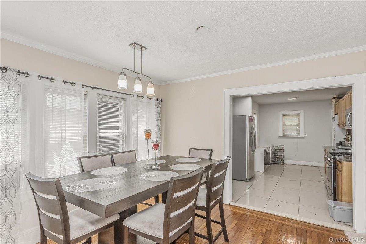 237 Rhodes Avenue Hempstead, NY 11550 - Photo 9 of 24 a view of a dining room with furniture window and wooden floor