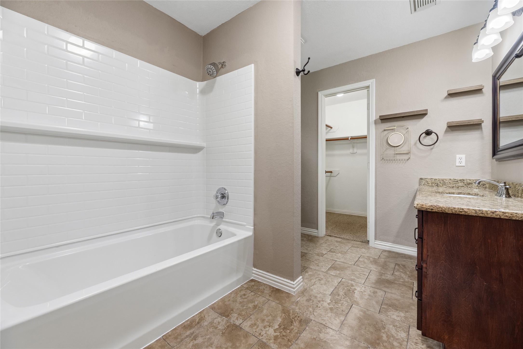 24006 Lazy Kay Lane Hockley, TX 77447 - Photo 13 of 21 Featuring a BRAND NEW shower/bathtub in the primary bathroom. The walk-in closet is highlighted here.