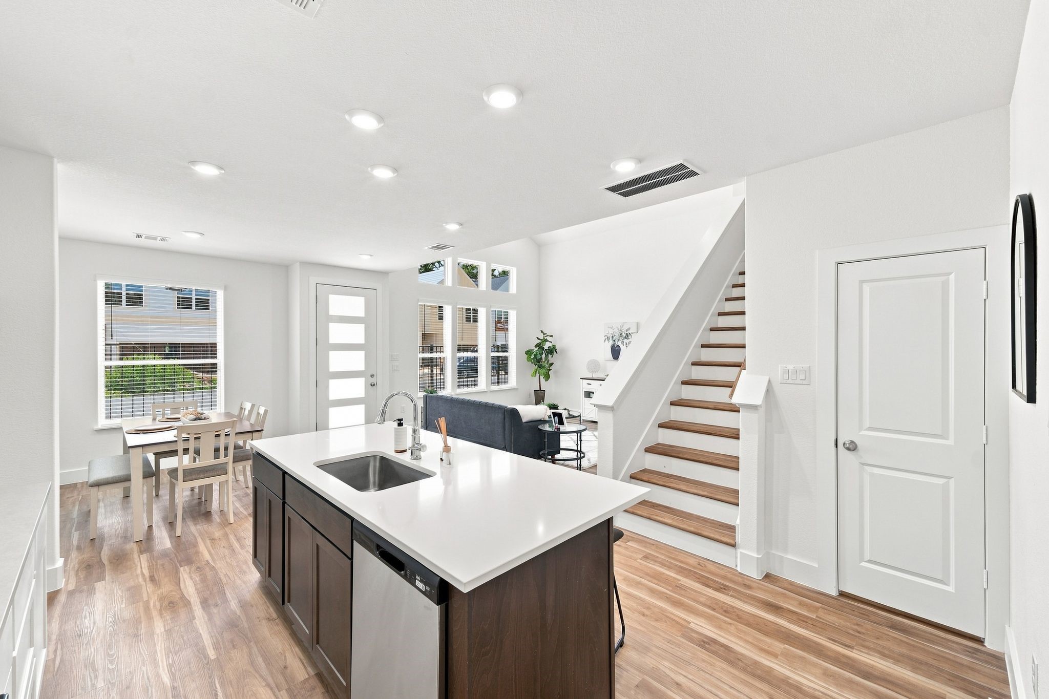6063 Cebra Street Houston, TX 77091 - Photo 29 of 50 Open-concept kitchen with a large quartz island, seamlessly connecting the kitchen, breakfast area, and living space. Photos are from a different property with the same floor plan, features, and finishes. **Orientation may vary.**
