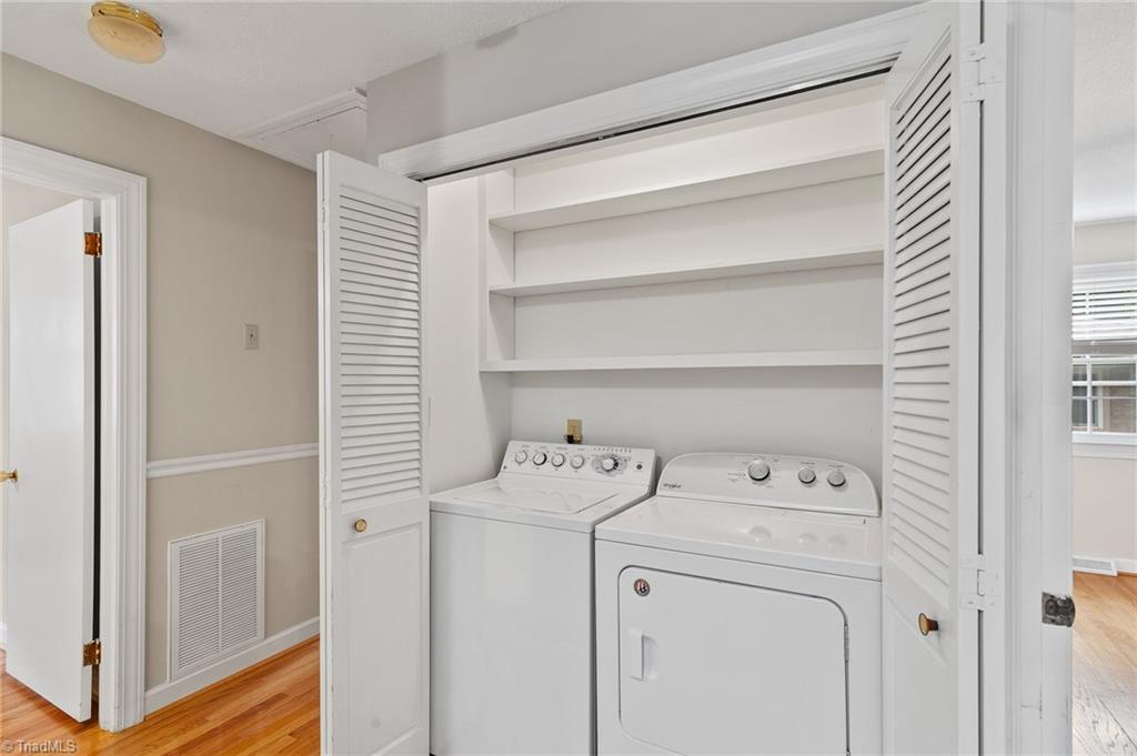 1610 Bolingbroke Road High Point, NC 27265 - Photo 16 of 24 Laundry area with plenty of wooden shelving, washer and dryer remain