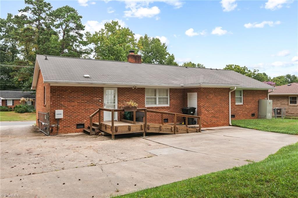 1610 Bolingbroke Road High Point, NC 27265 - Photo 21 of 24 Nice sized back deck off Kitchen, HUGE paved driveway area. * NOTE in the far left shows the gate for the electric gate that comes with a remote for extra privacy, keeping the dogs are kids in!