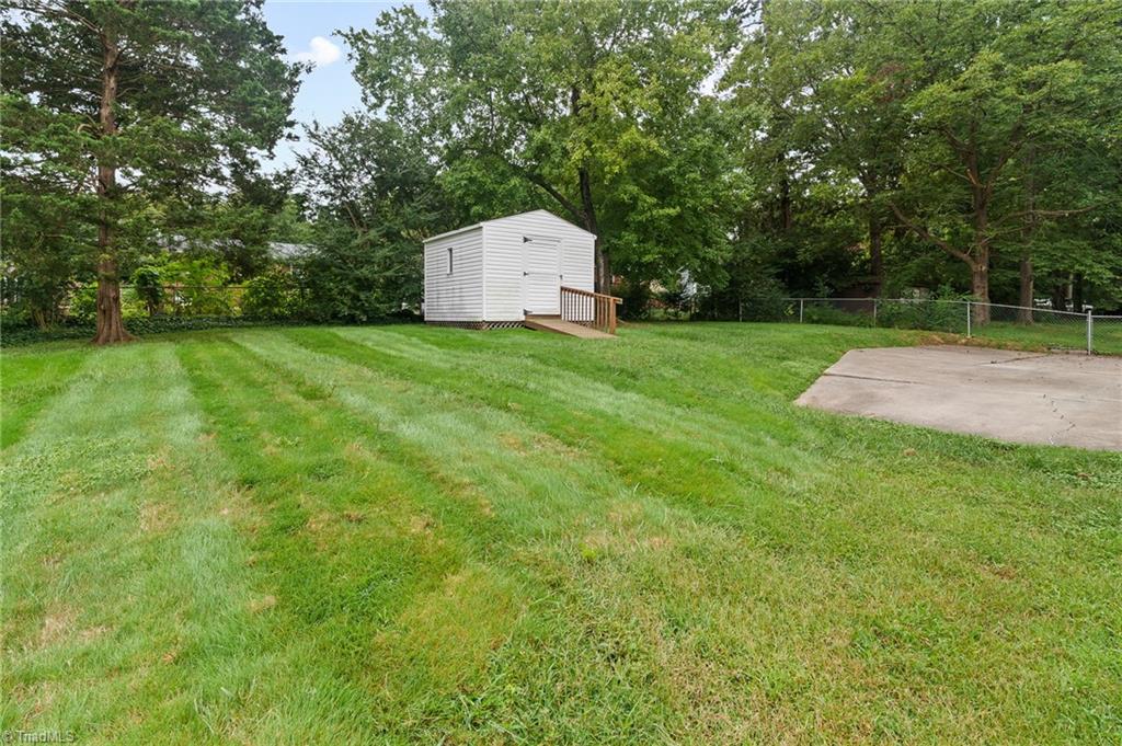 1610 Bolingbroke Road High Point, NC 27265 - Photo 22 of 24 LUSH level fenced backyard, wooded tree lined privacy!
