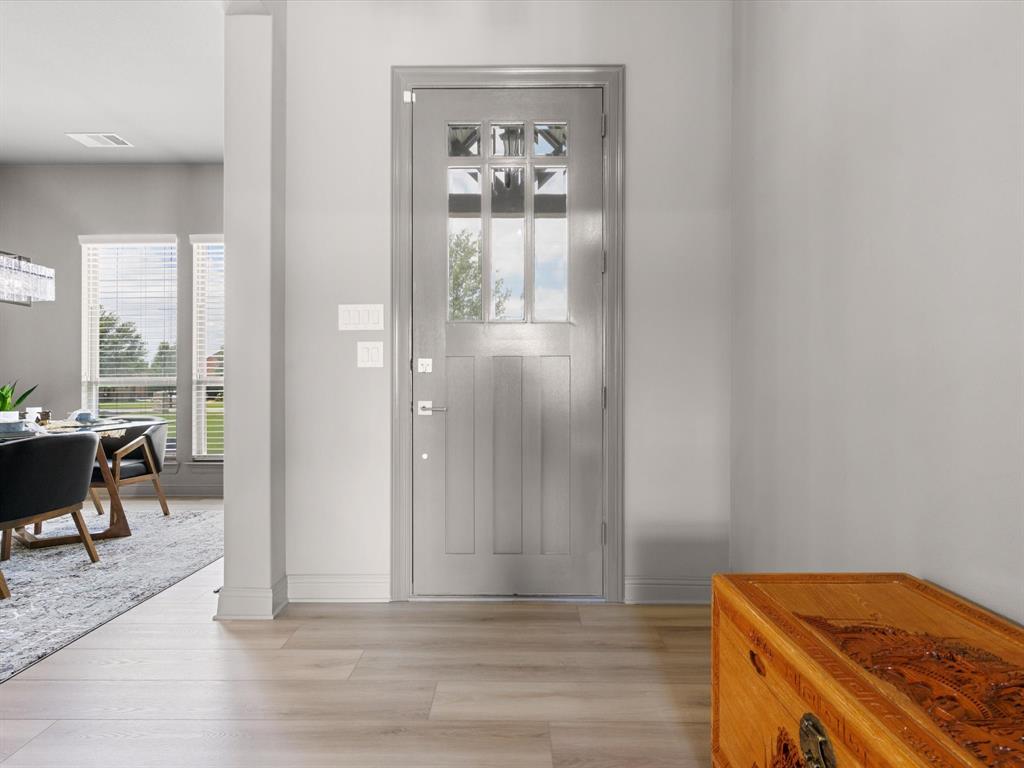 111 Old Base Road Aurora, TX 76078 - Photo 6 of 38 Welcoming entry with updated lighting, fresh paint, and views into the open-concept living spaces.