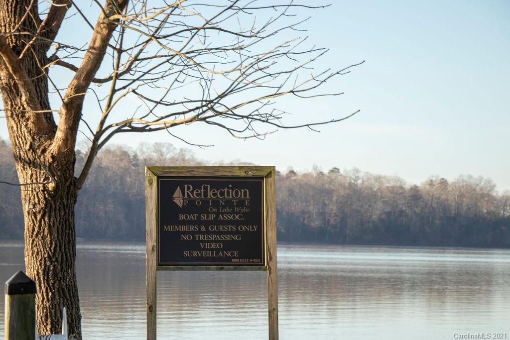 1105 Reflection Pointe Boulevard, Unit 13 Belmont, NC 28012 - Photo 14 of 25 a sign that is on a tree