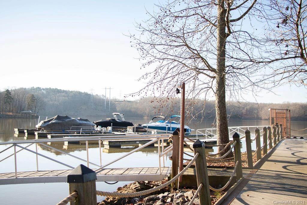 1105 Reflection Pointe Boulevard, Unit 13 Belmont, NC 28012 - Photo 19 of 25 a view of a swimming pool with outdoor seating and city view