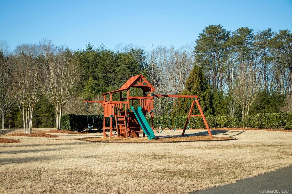 1105 Reflection Pointe Boulevard, Unit 13 Belmont, NC 28012 - Photo 22 of 25 a view of a park with swings and slides